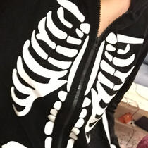 Cropped photo of someone wearing a skeleton onesie.